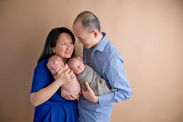 San Diego Newborn Photographer. Parents posing with twins