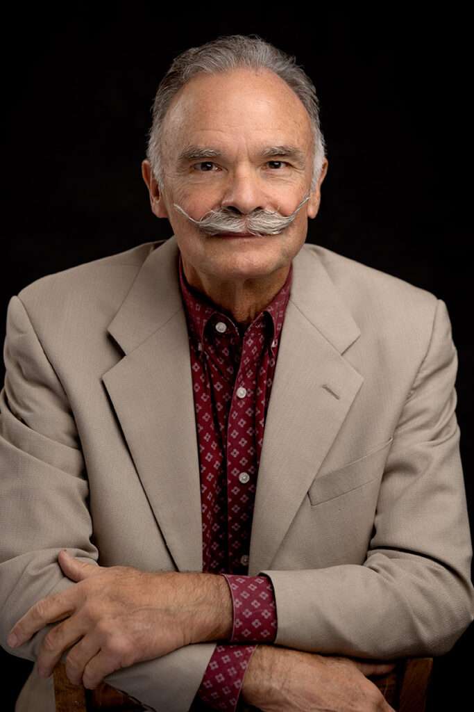 professional headshot of men wearing beige suite and burgundy shirt by san diego headshot photographer