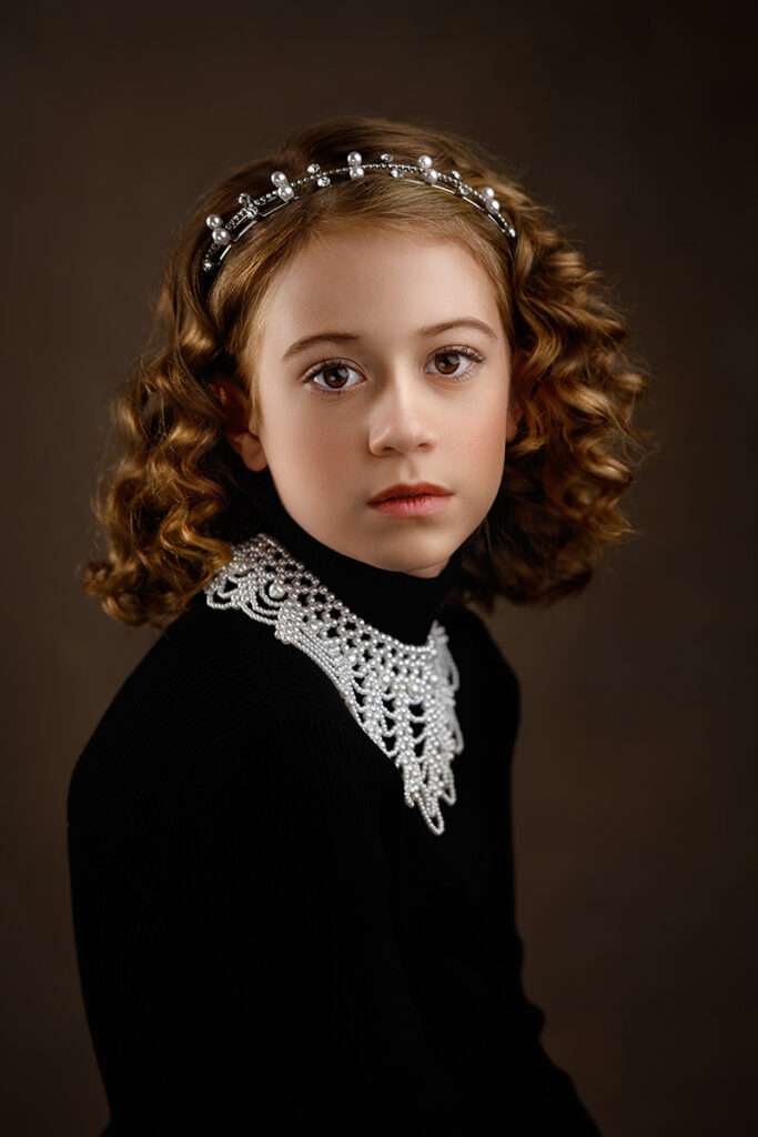 fine art portrait of a girl in black sweater and white pearl necklace photographed by best san diego photographer