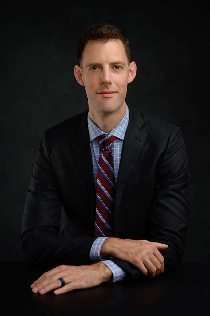 professional headshot of a young men wearing black suit by best san diego headshot photographer